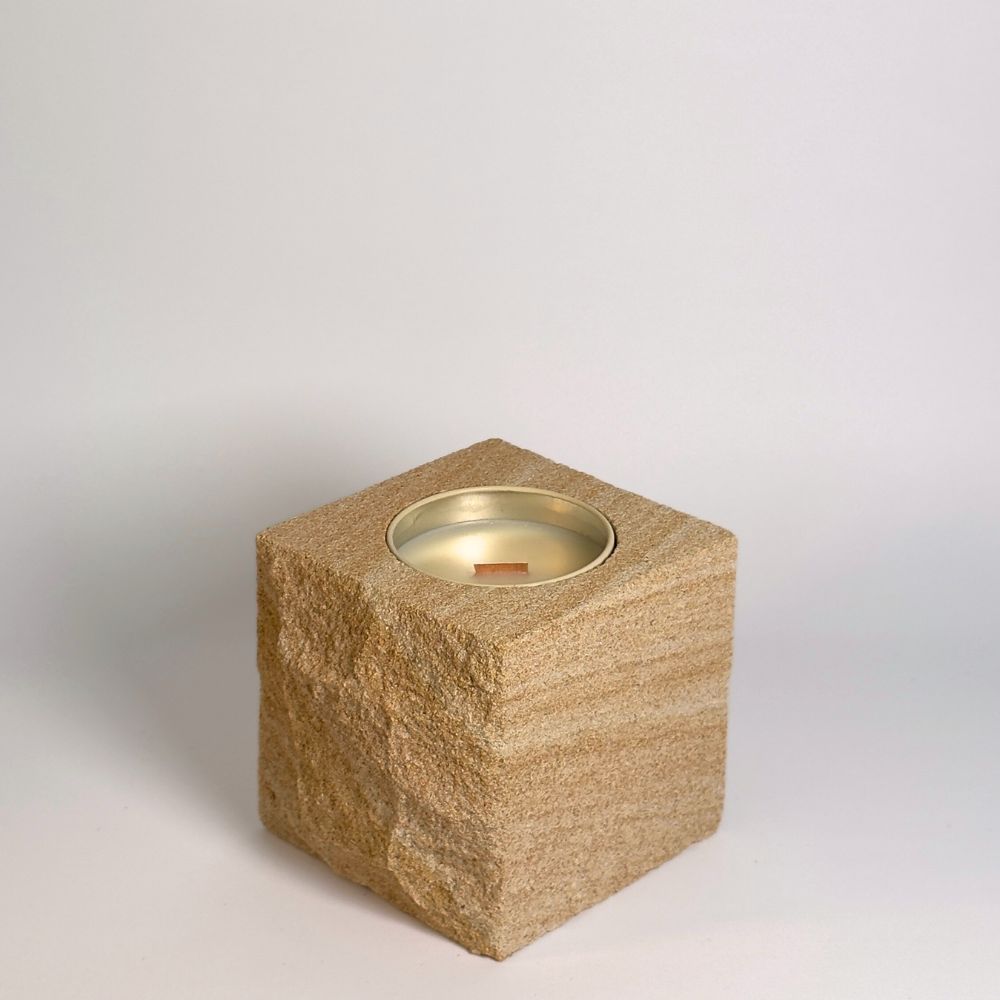 Beige 1 rck. refillable sandstone candle with rock faced side shown on the left