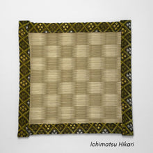 Square tatami coaster with a green and beige ichimatsu checkered pattern in the centre and a gold and olive patterned fabric border.