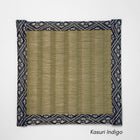 Square tatami coaster with a smooth olive igusa centre and a navy and white kasuri style geometric fabric border.