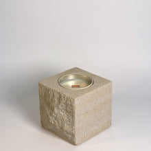 White rck. refillable sandstone candle with rock faced side shown on the left